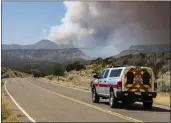  ?? ROBERT BROWMAN — THE ALBUQUERQU­E JOURNAL ?? A Cochiti Fire Department vehicle heads towards a plume of smoke from the Cerro Pelado Fire burning in the Jemez Mountains in Cochiti, N.M., on Friday.