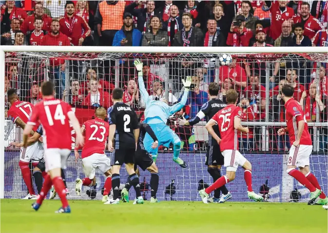  ??  ?? MUNICH: Bayern Munich’s Chilian midfielder Arturo Vidal (23) scores the first goal during the UEFA Champions League 1st leg quarter-final football match FC Bayern Munich v Real Madrid in Munich, southern Germany yesterday. — AFP