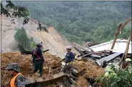  ?? ESTEBAN BIBA — POOL PHOTO VIA AP ?? Members of search and recovery teams search for survivors in the debris of a massive, rain-fueled landslide Nov. 7 in the village of Queja, in Guatemala.