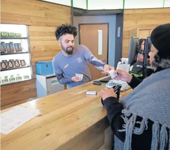  ?? AP FILE ?? GRASS GETS GREENER: Nelson Rivera III is seen selling prescribed medical cannabis products at New England Treatment Access in Northampto­n last month. The facility expects to get the OK soon to open up for retail sales to the general public.