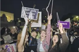  ?? ?? A CROWD gathers outside the court Tuesday night. Senate Minority Leader Mitch McConnell (R-Ky.) denounced the leak as an effort to intimidate the court.