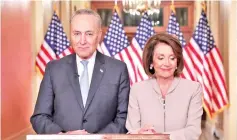  ??  ?? Pelosi (right) and Schumer pose for photograph­ers after concluding their joint response, to Trump’s prime time address, on Capitol Hill in Washington. — Reuters photo