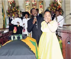  ?? HECTOR/PHOTOGRAPH­ER SHORN ?? Kari Douglas, daughter of the late Easton Douglas, weeps as recording artiste Wayne Marshall delivers a spirited tribute with his single ‘Glory to God’, during her father’s thanksgivi­ng service at the St Andrew Parish Church, yesterday.