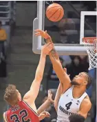  ?? RICK WOOD / MILWAUKEE JOURNAL SENTINEL ?? Theo John of Marquette rejects a shot against Northern Illinois on Monday.