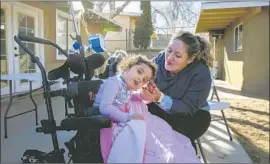  ?? Myung J. Chun Los Angeles Times ?? “I’M JUST TRYING to keep my daughter alive,” Amber Suarez says of Mia, 3. The pandemic has made home care even scarcer for medically fragile children.