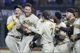  ?? AP photo ?? Padres pitcher Joe Musgrove (second from left) is mobbed by teammates after pitching a no-hitter against the Rangers on Friday.