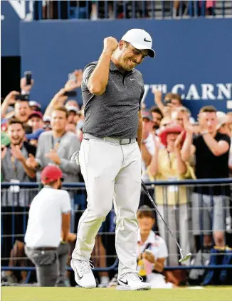  ?? HARRY HOW / GETTY IMAGES ?? Francesco Molinari celebrates a birdie on the 18th hole during the final round of the 147th British Open at Carnoustie on Sunday. Molinari is the first player from Italy to win one of golf’s majors.