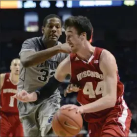  ?? ASSOCIATED PRESS ?? Dekker (44) looks for room around Penn State’s Jordan Dickerson (32) during the second half of an NCAA college basketball game Sunday, March 2, 2014 in State College, Pa. Wisconsin won 71- 66.