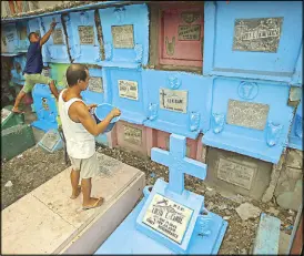  ?? KJ ROSALES ?? People clean the tombs of their departed loved ones at the Manila North Cemetery yesterday in preparatio­n for the observance of All Saints’ Day on Nov. 1.