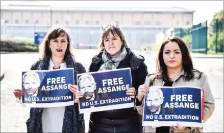  ?? AFP ?? Dozens of protesters gathered throughout the day outside the court, next to the high-security Belmarsh prison where Assange is being held, holding up banners and chanting loudly.