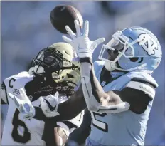  ?? ASSOCIATED PRESS ?? WAKE FOREST DEFENSIVE BACK JA’SIR TAYLOR (6) defends North Carolina’s Dyami Brown( 2) in the first half of a game Saturday in Chapel Hill, N.C. Taylor intercepte­d the pass.