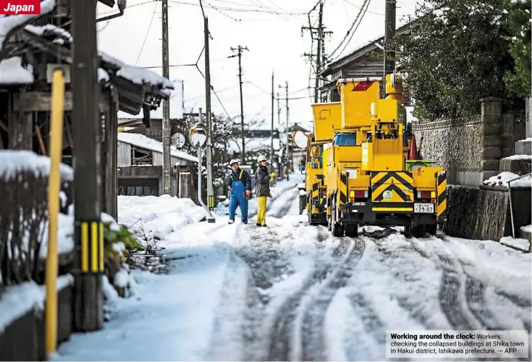  ?? AFP ?? Working around the clock: Workers checking the collapsed buildings at Shika town in Hakui district, Ishikawa prefecture. —