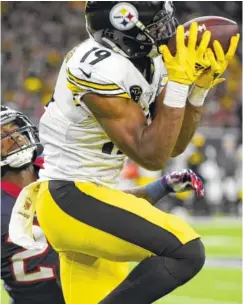  ?? THE ASSOCIATED PRESS ?? Pittsburgh Steelers wide receiver JuJu Smith-Schuster catches a pass against Houston Texans cornerback Kareem Jackson during the second half Monday in Houston. The Steelers won 34-6.