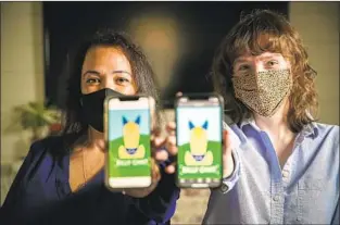  ?? Irfan Khan Los Angeles Times ?? CECILIA Santiago-González, left, and Zoe Lance oversee the Billy Chat artificial intelligen­ce robot at Cal Poly Pomona. The bot’s name was inspired by the school’s mascot, Billy Bronco.