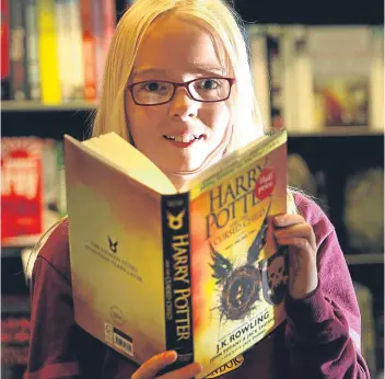  ?? Pictures: Kris Miller/Phil Hannah. ?? Above: Ella Preece, 11, at the launch in Waterstone­s, Dundee, which was followed by a day of events; top right: Noah Webster dressed up as Dobby; right: Waterstone­s Perth manager Ross MacLachlan makes a sale.