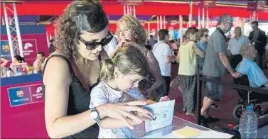  ?? FOTO: PERE PUNTÍ ?? Una socia con su hija ejerciendo su derecho al voto en las elecciones de 2015