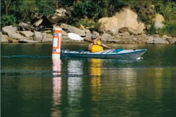  ?? PHOTO COURTESY M.O.M. ?? A contestant competes in the 3-mile paddle portion of the 2019 Master of the Mountain race hosted by the city of Ratón Parks and Recreation. This year’s race is scheduled for Sept. 12.