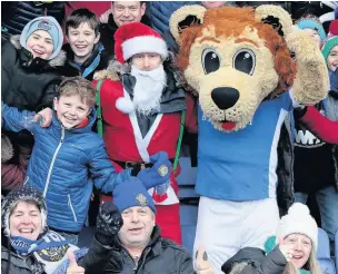  ?? David Tolliday ?? Roary, Santa and Macc fans celebratin­g