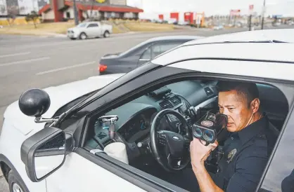  ?? Michael Ciaglo, Special to The Denver Post ?? Denver police traffic Officer John Bolen watches for speeders traveling north on Federal Boulevard on Thursday. Officers are issuing 45 percent fewer tickets now than they were 10 years ago, which some city officials have blamed for a recent rise in accidents. Another factor: The traffic unit patrol staff has dwindled since 2009.