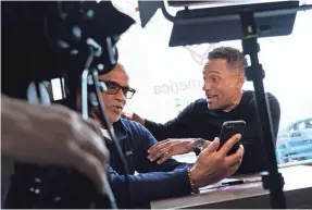  ?? RYAN GARZA/DETROIT FREE PRESS VIA USA TODAY NETWORK ?? Actor Hill Harper, right, talks with Matthew Evans while filming a promotion for an effort to build credit scores.