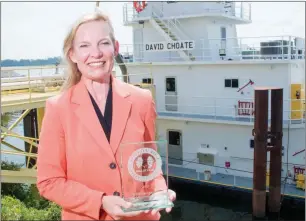  ?? WILLIAM HARVEY/THREE RIVERS EDITION ?? Penny Choate stands in front of the Arkansas River holding David Choate’s Arkansas River Hall of Fame award plaque. She described her husband, who died earlier this year after a long battle with brain cancer, as a caring person and a brilliant...