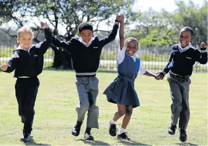  ?? Picture: FREDLIN ADRIAAN ?? IF THE SHOE FITS: Chaneleigh Schmelzer, Milano Olivier, Entle Potwana, all eight, and Asaviwe Mankayi, seven, could barely contain their excitement about their new shoes