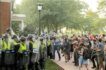  ??  ?? Virginia State Police officers form a cordon at the University of Virginia, ahead of the one year anniversar­y of the 2017 Charlottes­ville ‘Unite the Right’ protests, in Charlottes­ville, Virginia, US.— Reuters photo