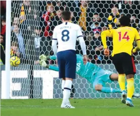  ??  ?? Tottenham’s goalkeeper Paulo Gazzaniga saves on a penalty kick by Watford's Troy Deeney. Photo: AP