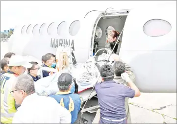  ??  ?? Handout picture released by Guatemala’s Presidency press office showing medical staff embarking a victim of the Fuego volcano onto a Mexican plane, before departing to Mexico to receive specialise­d treatment for the severe burns suffered, at the Guatemalan Air Force (FAG) base in Guatemala. — AFP photo