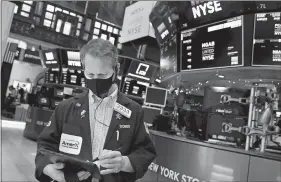  ?? NICOLE PEREIRA, NEW YORK STOCK EXCHANGE VIA AP ?? Trader Robert Charmak works on the floor of the New York Stock Exchange last week in New York.