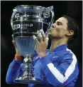  ?? ALASTAIR GRANT — THE ASSOCIATED PRESS ?? Spain’s Rafael Nadal hoists the trophy awarded to him Friday for securing the season-ending No. 1 ranking for the fifth time in his career.