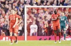  ?? — AFP photo ?? Liverpool’s English midfielder James Milner (L) reacts after Dortmund scored their first goal during the UEFA Europa league quarter-final second leg football match between Liverpool and Borussia Dortmund at Anfield stadium in Liverpool on April 14, 2016.