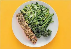  ??  ?? Caper-baked salmon with lemon peas, leek, kale and broccoli.