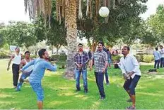  ??  ?? Below: A group of Indian workers enjoy an impromptu game of volleyball in the Family Park near the Abu Dhabi Corniche yesterday. Abdul Rahman/Gulf News