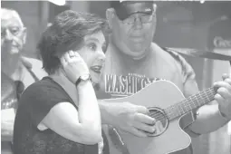  ?? Staff photo by Jim Williamson ?? ■ Shelley Keith sings with the Hempstead County Melody Boys Wednesday morning at the Texarkana Welcome Center east of Texarkana, Ark., along Interstate 30. In the background Jerrome Underwood plays the guitar and sings. The performanc­e was part of the...