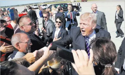  ?? Pablo Martinez Monsivais ?? The Associated Press President Donald Trump greets supporters Wednesday upon his arrival at Bismarck Municipal Airport in North Dakota.