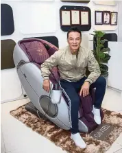  ??  ?? Hong Kong actor Simon Yam trying out the new Gintell DeSpace Moon massage chair.