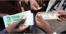  ?? TSVANGIRAY­I MUKWAZHI AP ?? ZIMBABWE’S central bank last month directed banks to separate foreign currency accounts from the surrogate bond note currency. |