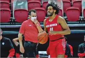  ?? COURTESY UNM ATHLETICS ?? New Mexico head coach Paul Weir gives instructio­n to point guard Jeremiah Francis in the first half of Monday’s game against UNLV in Las Vegas, Nev. The Lobos missed 19 of their final 22 shots and lost 53-46, their eighth straight loss in conference play.