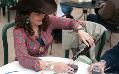  ?? J. Patric Schneider ?? Mandy Jackson pours a glass of wine at the Champion Wine Garden.