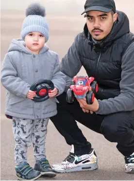  ??  ?? Off the road: Idrees Waiyasil and father Hariz with his toy car