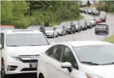  ?? ETHAN HYMAN/THE NEWS & OBSERVER VIA AP ?? Cars line up for gas Wednesday in Apex, N.C.