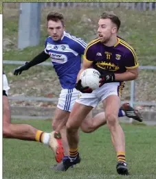  ??  ?? Wexford’s Jonathan Bealin is watched by Ross Munnelly of Laois.