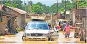  ?? (AFP) ?? A man drives his vehicle through flooded street after a heavy rainfall in Dimapur in the north eastern state of Nagaland on July 14