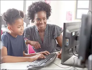  ?? (Pic: UNESCO.org) ?? A mother helping her daughter how to use a computer.