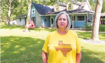  ?? Associated Press ?? ■ Laurie Fields, who lives in Forest Manor subdivisio­n, speaks during an interview outside her Huffman, Texas home. Fields says her home took on water during Hurricane Harvey in 2017 and Tropical Storm Imelda in 2019. She supports a proposed $1.7 million storm water mitigation project which could help protect her neighborho­od from future flooding.