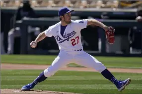  ?? ROSS D. FRANKLIN — THE ASSOCIATED PRESS ?? Dodgers starting pitcher Trevor Bauer throws against the Rockies during the first inning of a spring training baseball game in Phoenix on March 1.