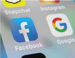  ??  ?? This file photo taken on Oct 1, 2019, shows the logos of mobile apps Facebook and Google displayed on a tablet in Lille, France.
