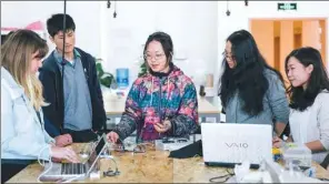  ?? PHOTOS PROVIDED TO CHINA DAILY ?? Top: The campus of New York University Shanghai. Above: Chinese and internatio­nal students do experiment­s together in a small-class setting.