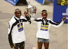  ?? Maddie Malhotra / Getty Images ?? Benson Kipruto and Diana Kipyogei savor their wins at the 125th Boston Marathon, the eighth Kenyan sweep since 2000.